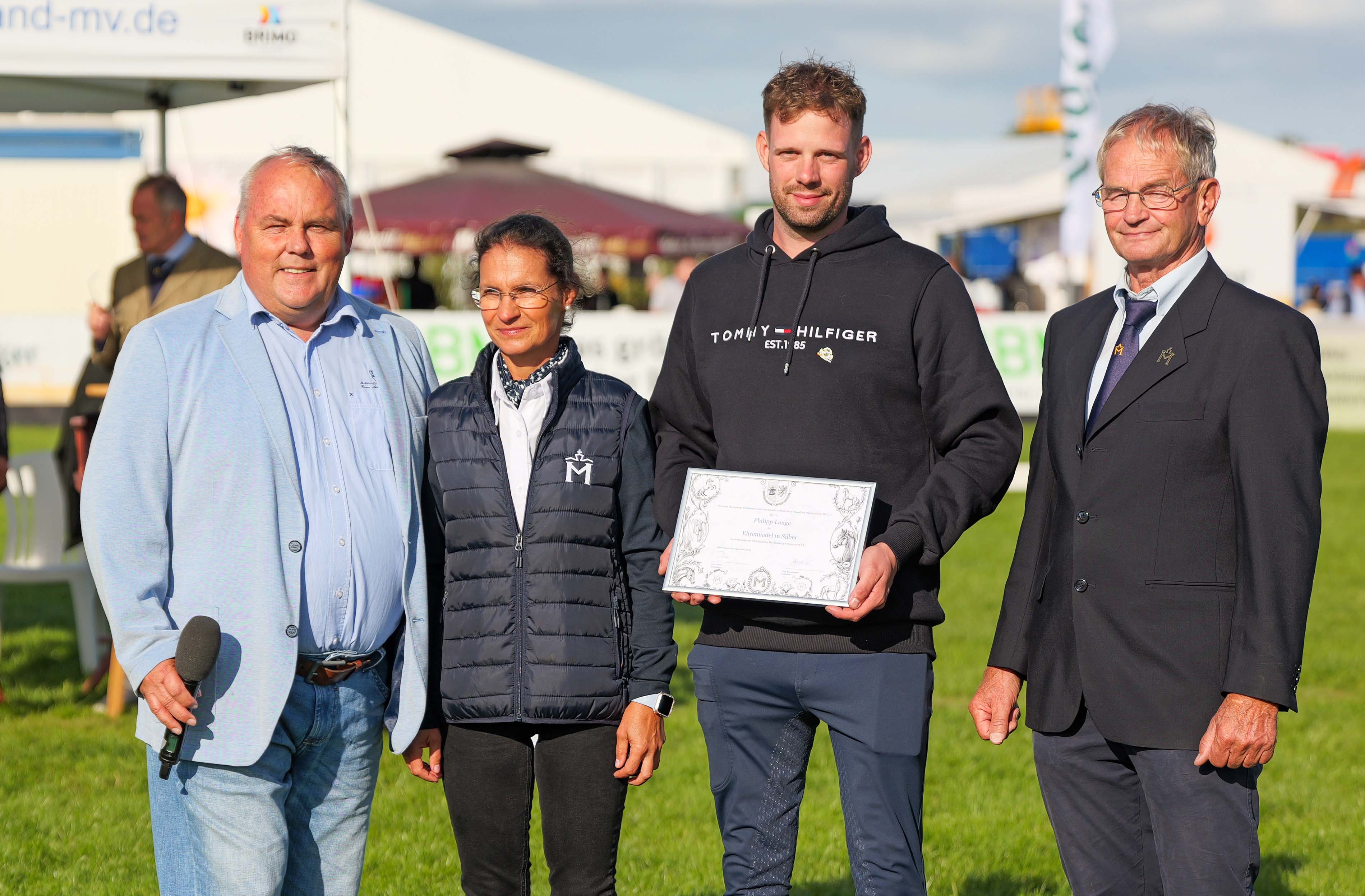 Einer der seit Jahren als Helfer für den Zuchtverband bei der MeLa und der Elitestutenschau in unermüdlichem Einsatz ist, das ist Philipp Lange, der seinen Wohnsitz von Torgelow in die Nähe von Neustadt-Dosse verlegt hat. Bei der diesjährigen Schau wurde er dafür von Verbandspräsident Jörg Hasselmann, Präsidiumsmitglied Sandra Engelmann und Zuchtleiter Uwe Träder mit der Ehrennadel des Verbandes ausgezeichnet.